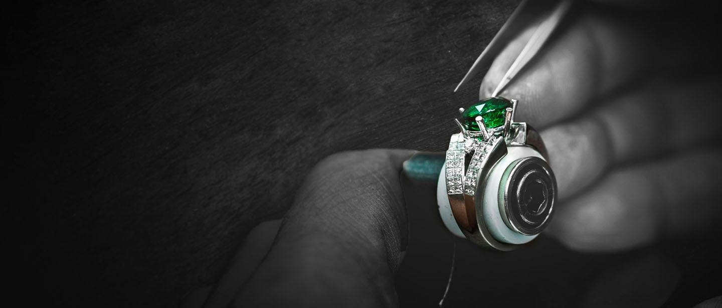 Nelson craftsman stone setting precious emerald into a18 karat gold diamond semi mounted fine jewellery ring